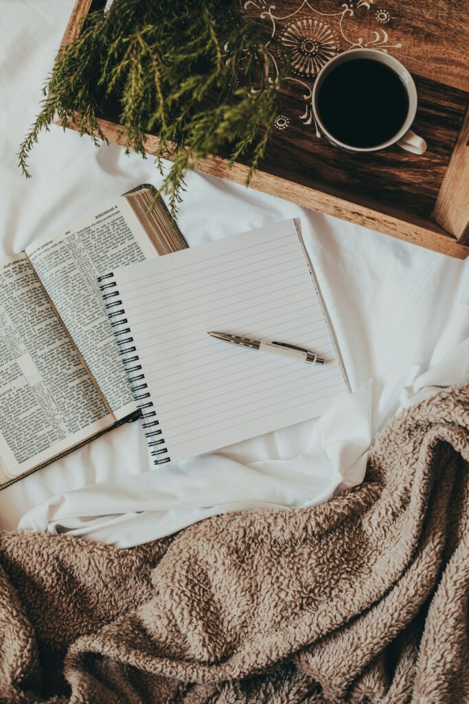 a journal and a pen with a bible taking notes for Christian counseling