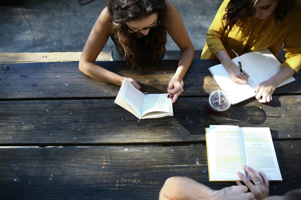 a family engaging in family therapy around a picnic table shot from above.