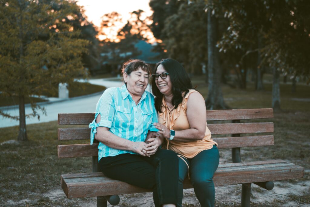 happy couples on a bench in a park experience a stronger family with counseling