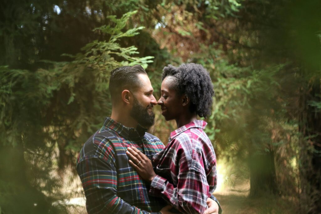 a couple intimately embracing under trees after completing sex therapy