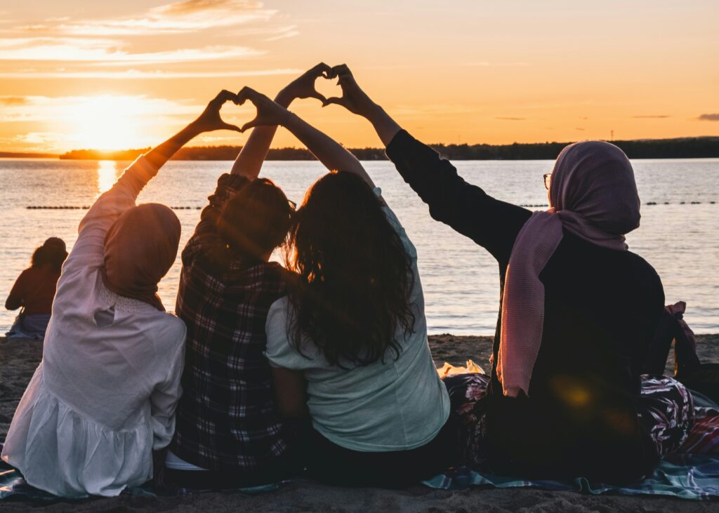 a family at the beach holding their hands up making a heart shape with family counseling