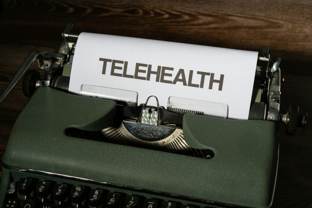 a typewriter with the word telehealth on the paper.